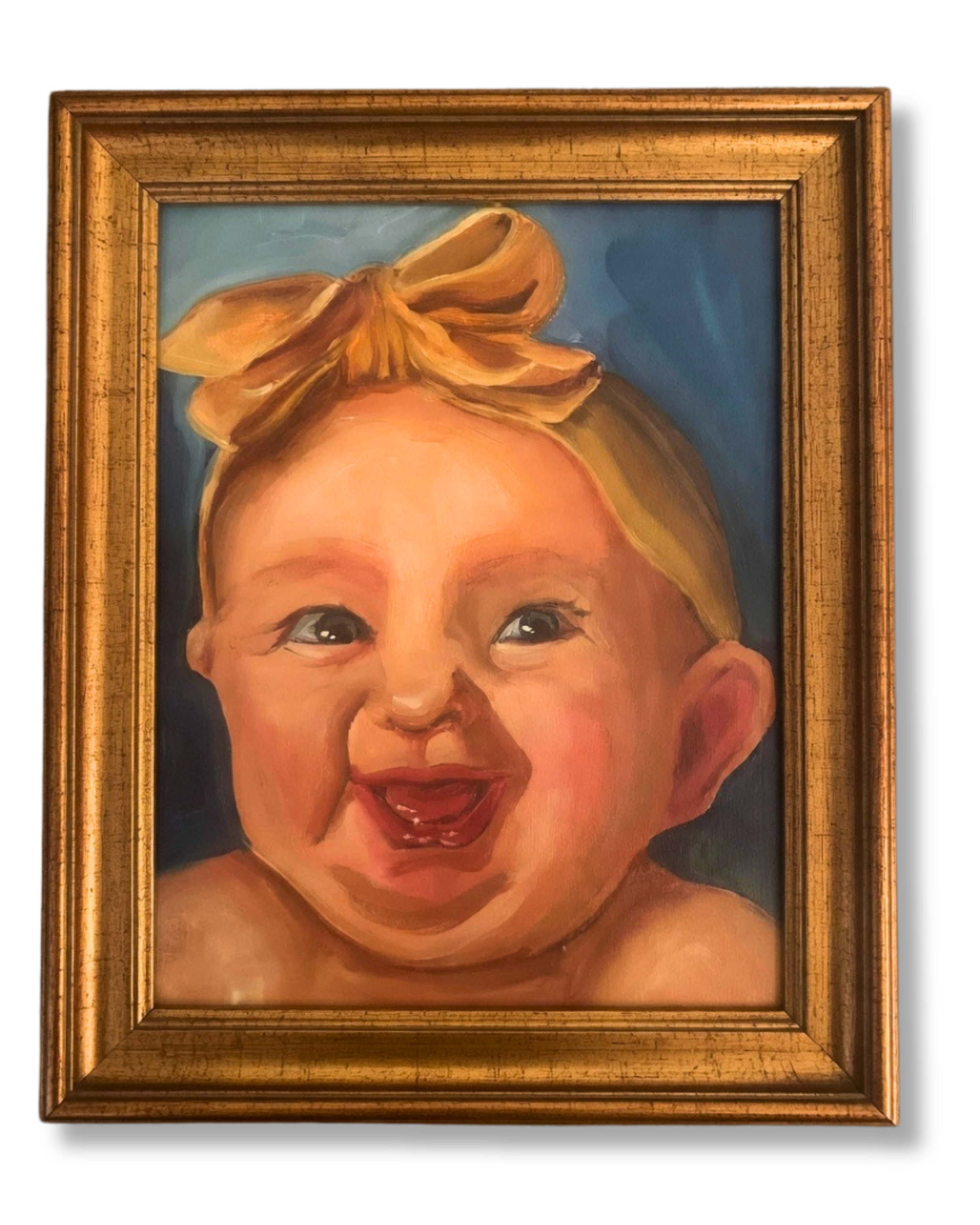 Framed Portrait of a Smiling, Happy Baby Girl A custom oil portrait of a laughing baby girl with a yellow bow and blue eyes, framed in a gold picture frame